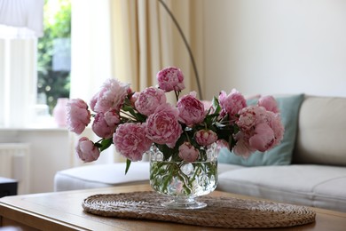 Beautiful pink peonies in vase on table at home. Interior design