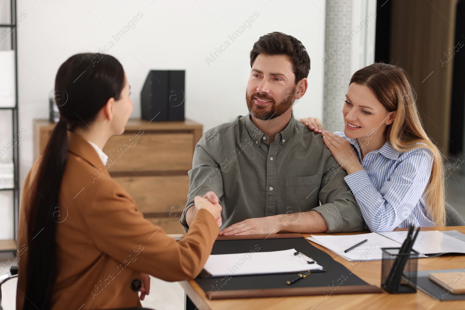 Photo of Lawyer shaking hands with clients in office