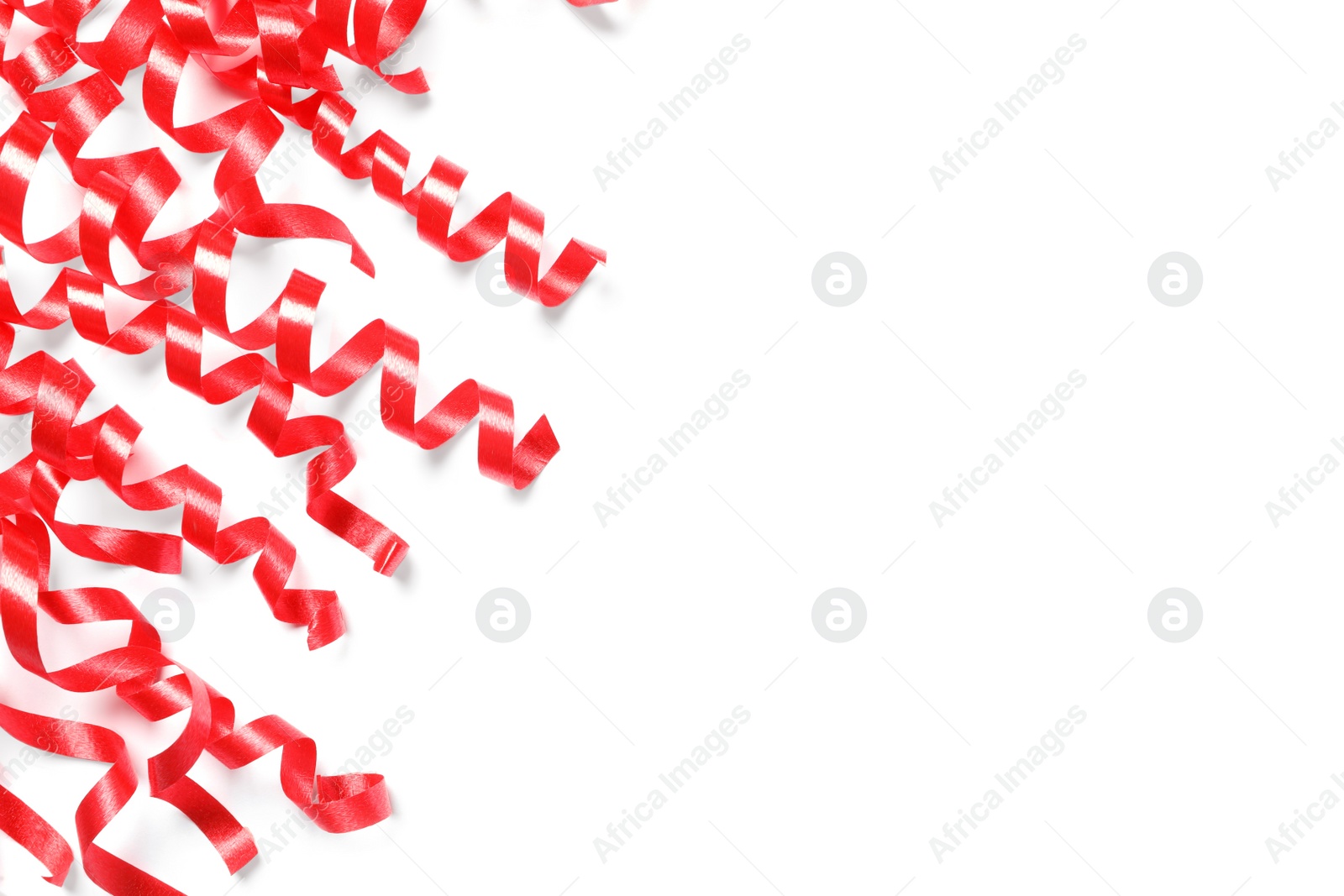 Photo of Red serpentine streamers on white background, top view