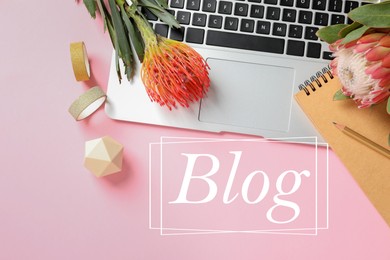 Image of Blogger's workplace with laptop and flowers on pink background, flat lay