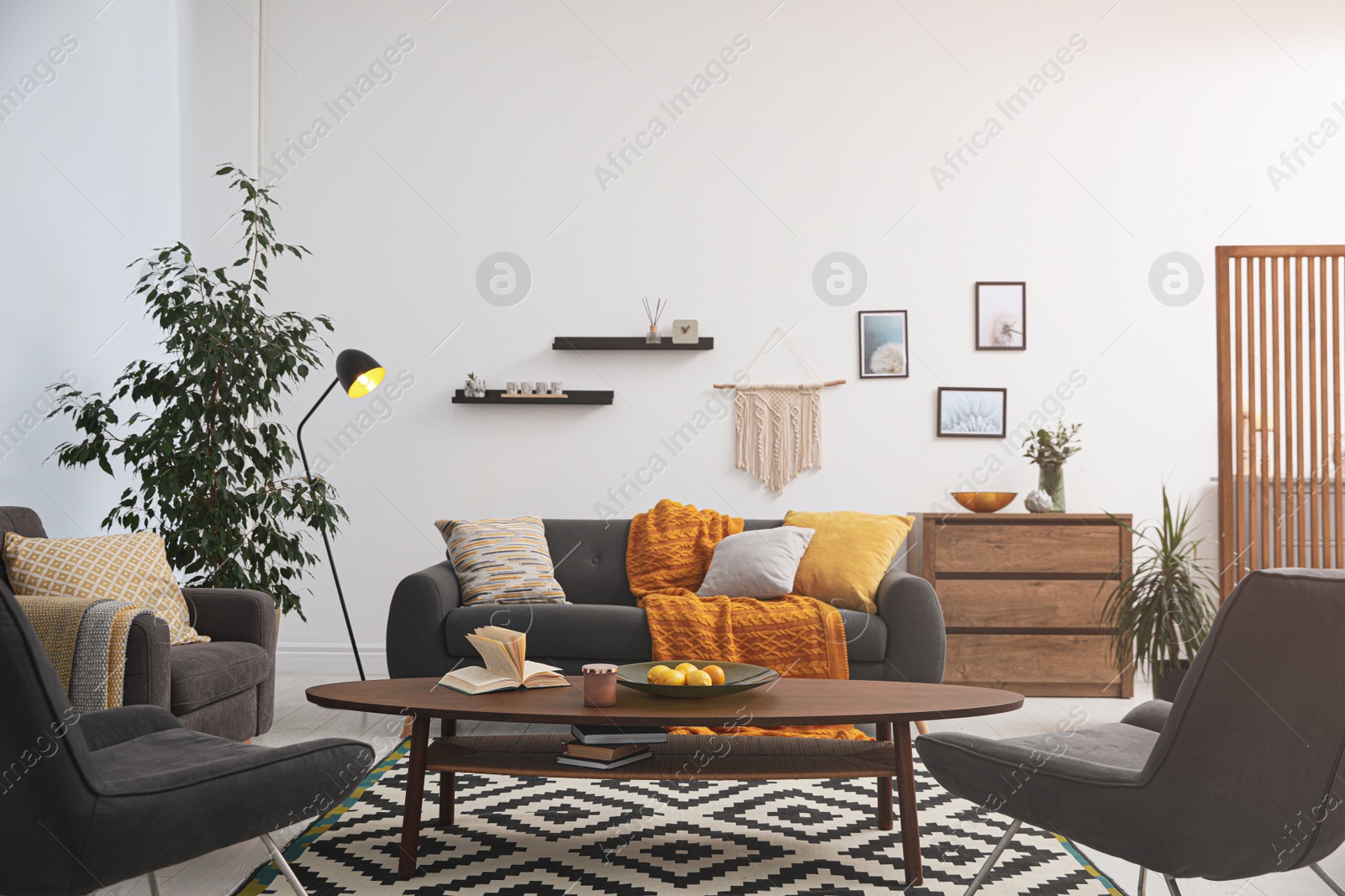 Photo of Stylish living room interior with comfortable sofa and wooden table