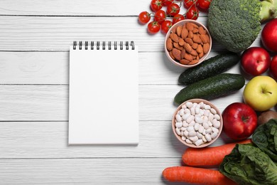 Photo of Notebook. fresh fruits and vegetables on white wooden table, flat lay. Low glycemic index diet