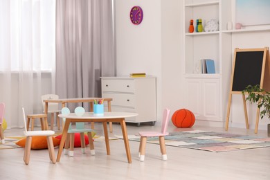 Child`s playroom with comfortable furniture. Stylish kindergarten interior