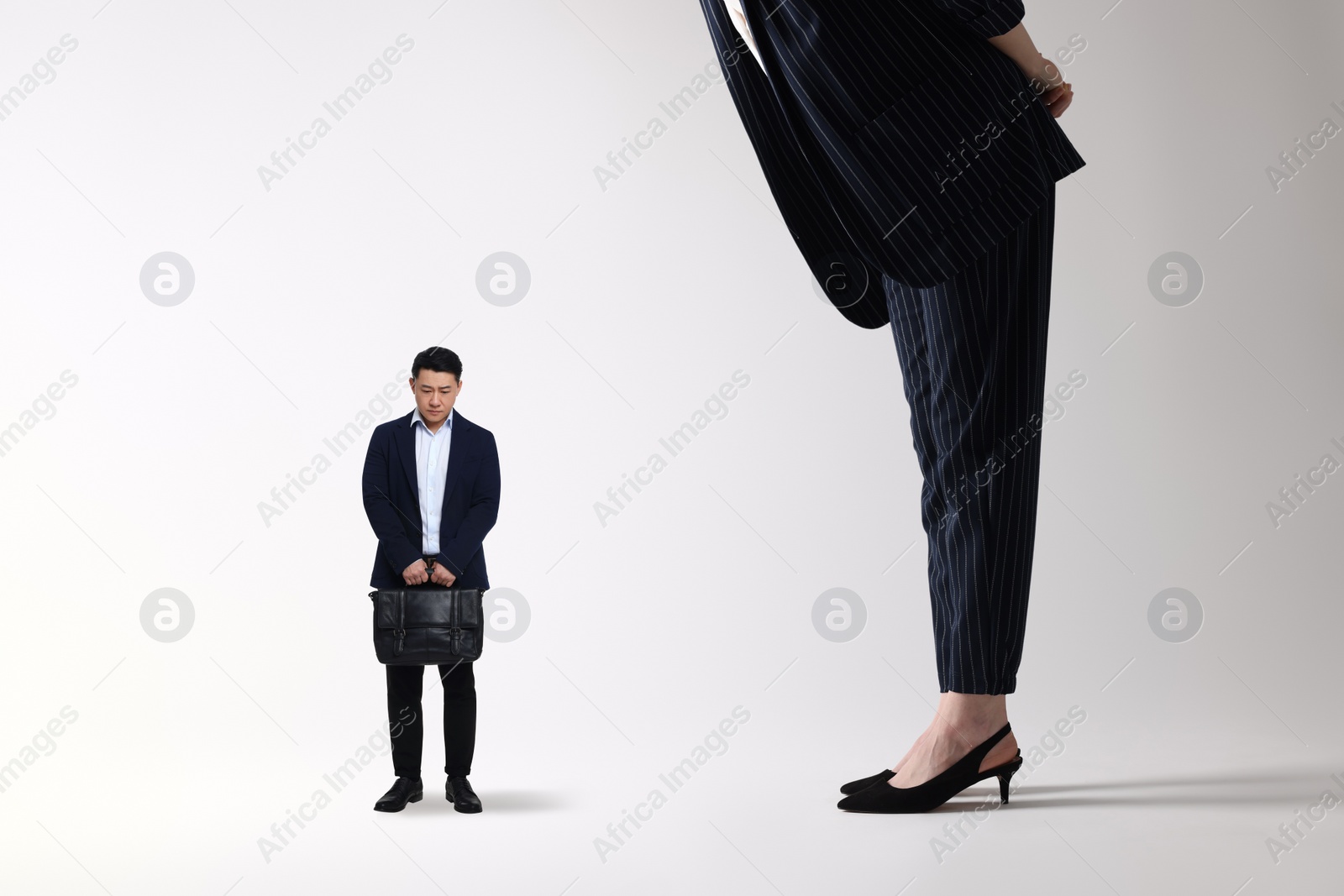 Image of Giant woman and sad small man on light background