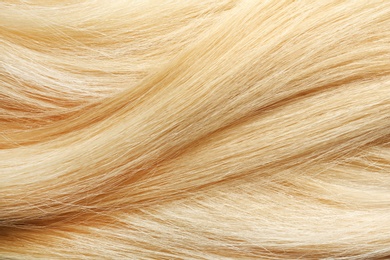 Photo of Texture of healthy blond hair as background, closeup