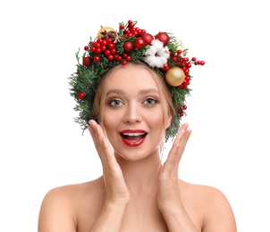 Photo of Beautiful young woman wearing Christmas wreath on white background