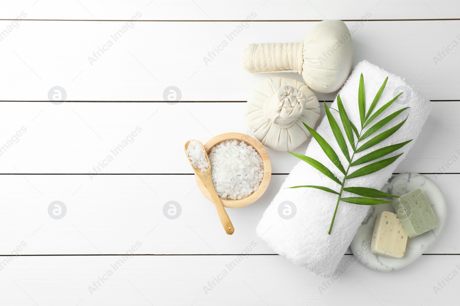 Photo of Flat lay composition with different spa products on white wooden table. Space for text