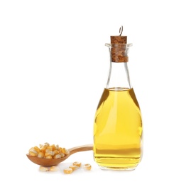 Photo of Bottle with fresh corn oil and kernels on white background