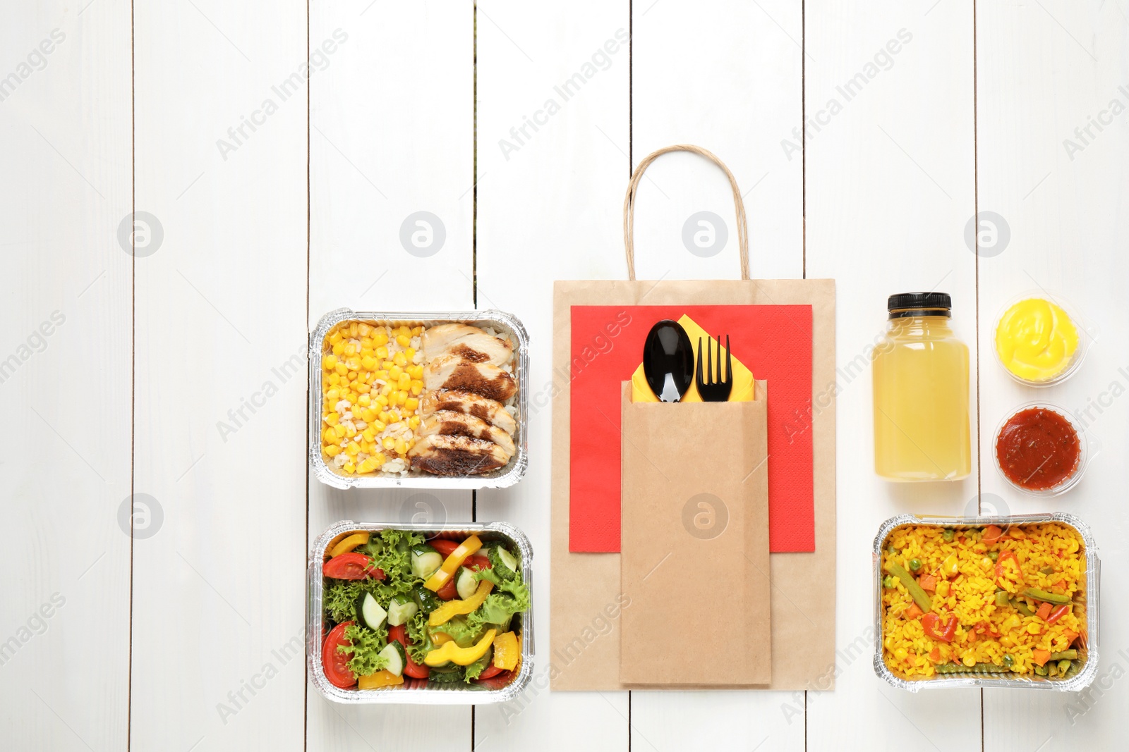 Photo of Lunchboxes on white wooden table, flat lay. Healthy food delivery