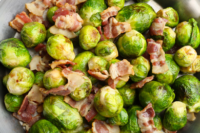 Photo of Delicious Brussels sprouts with bacon, top view