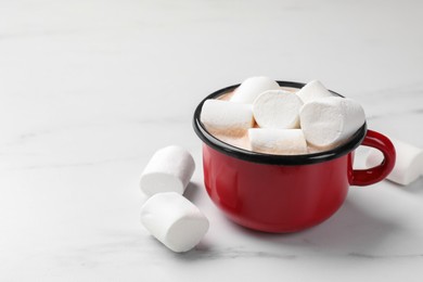 Tasty hot chocolate with marshmallows on white marble table, closeup. Space for text