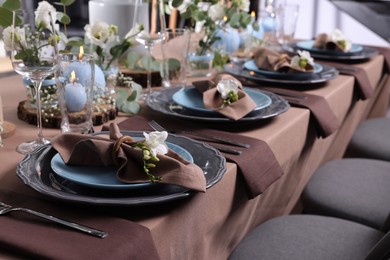 Elegant table setting with beautiful floral decor and burning candles