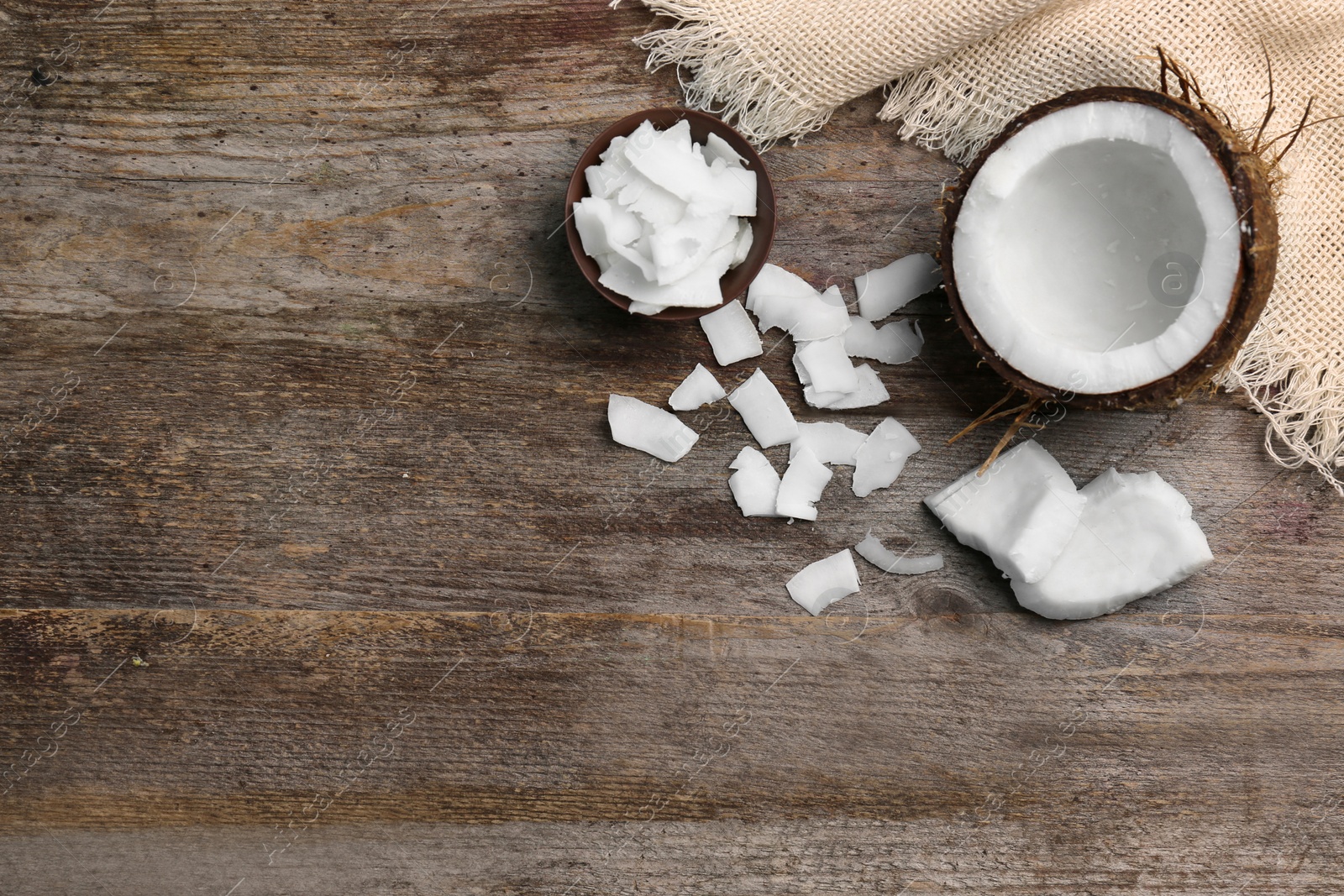 Photo of Composition with fresh coconut flakes on wooden background