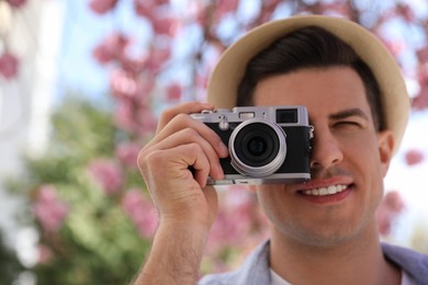 Photo of Tourist taking picture on beautiful city street