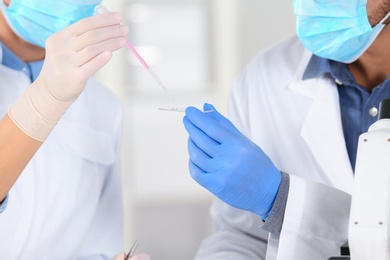 Photo of Scientists working in laboratory, closeup view. Research and analysis