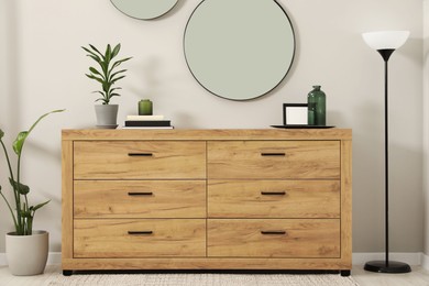 Cozy room interior with chest of drawers, mirrors and decor elements