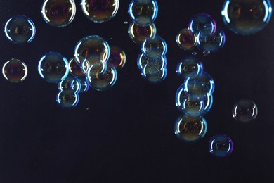 Beautiful transparent soap bubbles on dark background