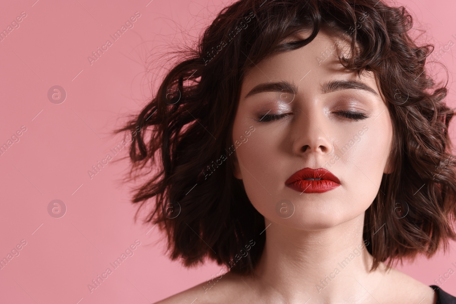 Photo of Portrait of beautiful young woman with wavy hairstyle on pink background. Space for text