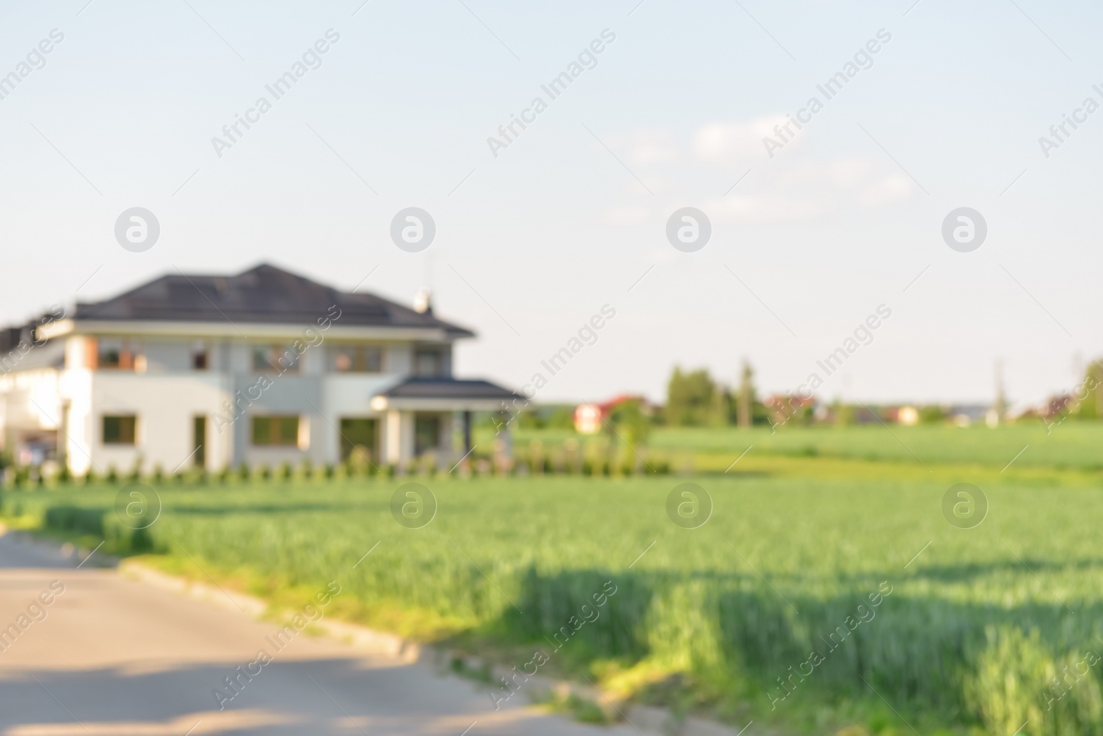 Photo of Blurred view of modern house near beautiful meadow on sunny day