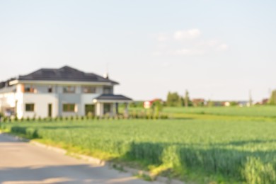 Photo of Blurred view of modern house near beautiful meadow on sunny day