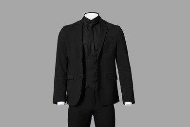 Photo of Male mannequin dressed in stylish black suit on grey background