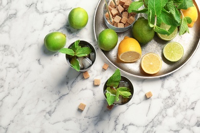 Photo of Flat lay composition with delicious mint julep cocktail on marble background