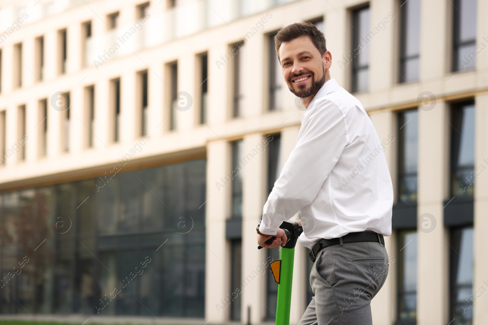 Photo of Businessman with modern kick scooter on city street, space for text