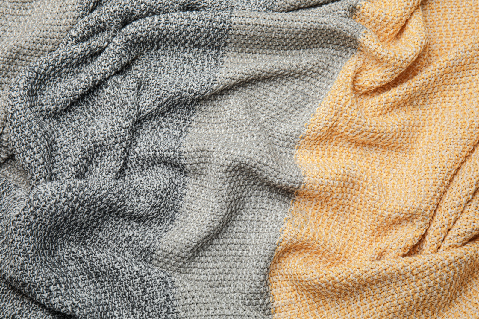 Photo of Soft crumpled knitted plaid as background, top view