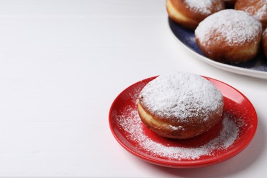 Photo of Delicious sweet buns on white table, closeup. Space for text