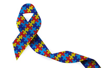 World Autism Awareness Day. Colorful puzzle ribbon on white background, top view