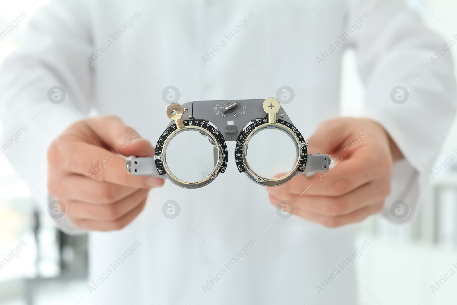 Photo of Ophthalmologist with trial frame in clinic, closeup