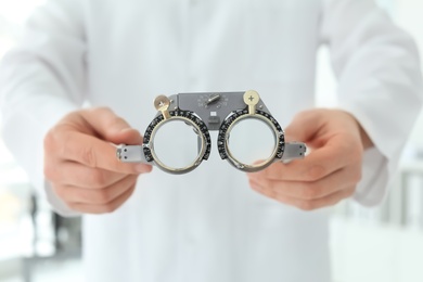 Photo of Ophthalmologist with trial frame in clinic, closeup