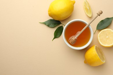 Ripe lemons, leaves, bowl of honey and dipper on beige background, flat lay. Space for text