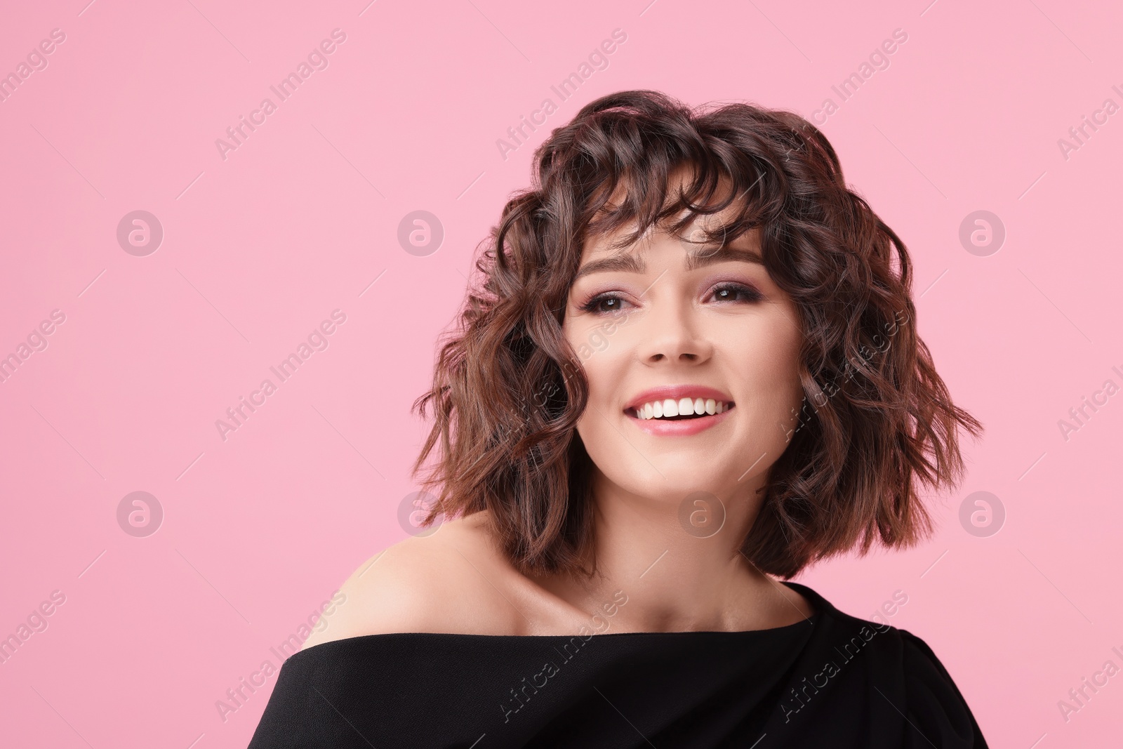 Photo of Portrait of beautiful young woman with wavy hairstyle on pink background. Space for text