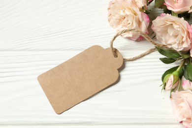 Happy Mother's Day. Beautiful flowers with blank card on white wooden table, flat lay