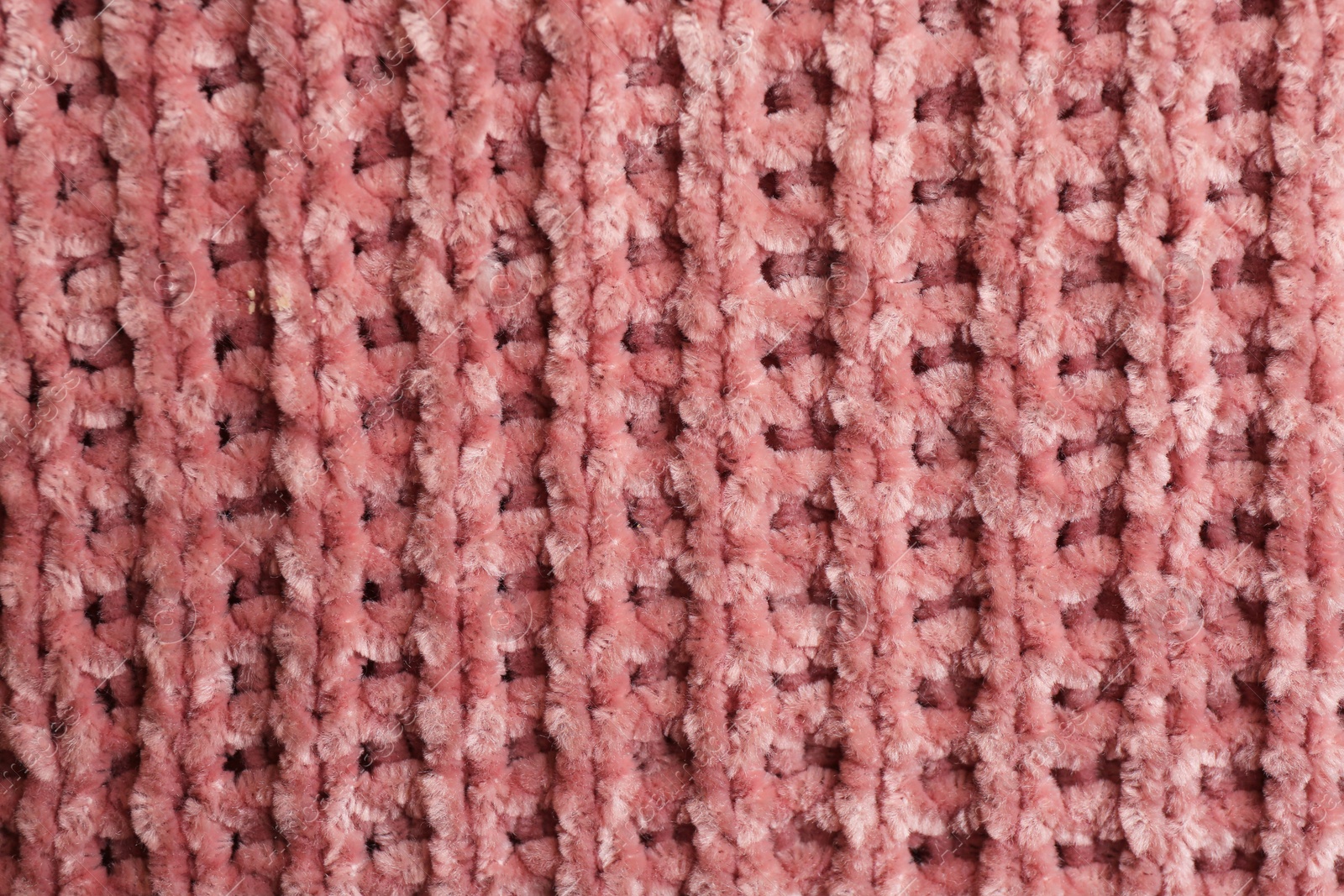 Photo of Beautiful pink knitted fabric as background, top view