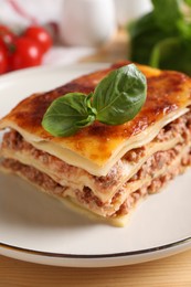 Photo of Delicious cooked lasagna served on table, closeup