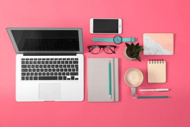 Photo of Flat lay composition with laptop and office tools on pink background