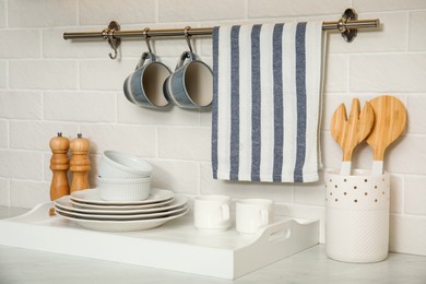 Photo of Clean towel, utensils and dishware in kitchen
