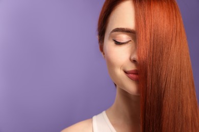 Beautiful woman with red dyed hair on purple background, space for text