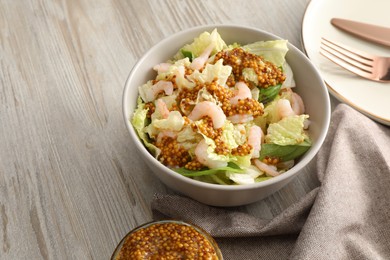 Photo of Delicious salad with Chinese cabbage, shrimps and mustard seed dressing on white wooden table, space for text