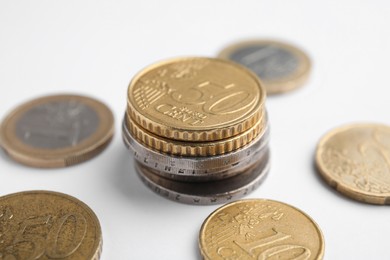 Photo of Many Euro coins on white background, closeup. National currency