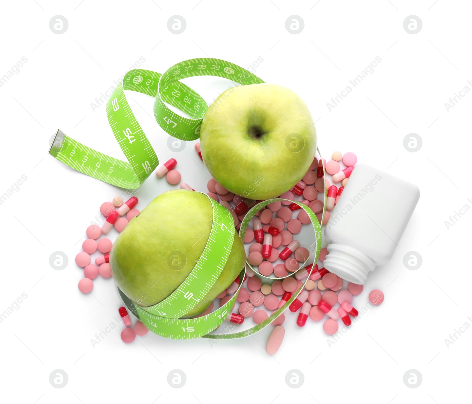 Photo of Weight loss pills, apples and measuring tape on white background, top view