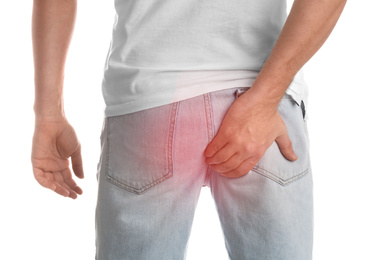 Image of Man suffering from hemorrhoid on white background, closeup
