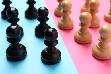 Chess pieces on color background, closeup. Gender equality