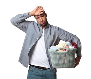 Photo of Tired man with basket full of laundry on white background