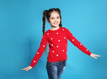 Photo of Portrait of little girl posing on color background