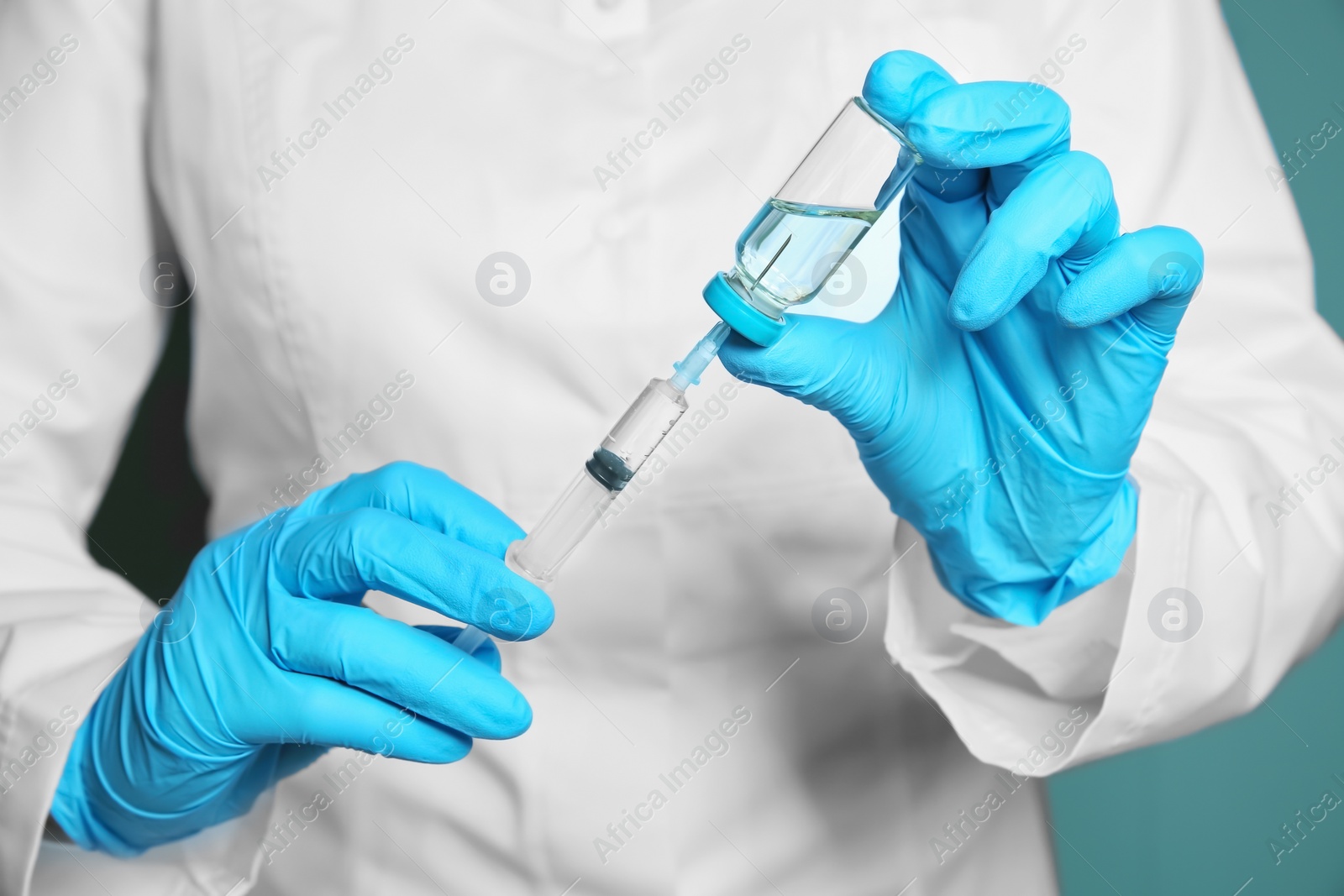 Photo of Doctor with syringe and medicine for vaccination, closeup