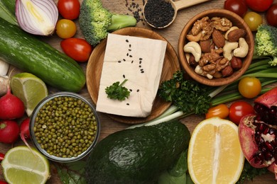 Photo of Different vegetables on wooden table, flat lay. Vegan diet