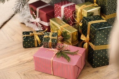 Photo of Many different Christmas gifts on floor indoors